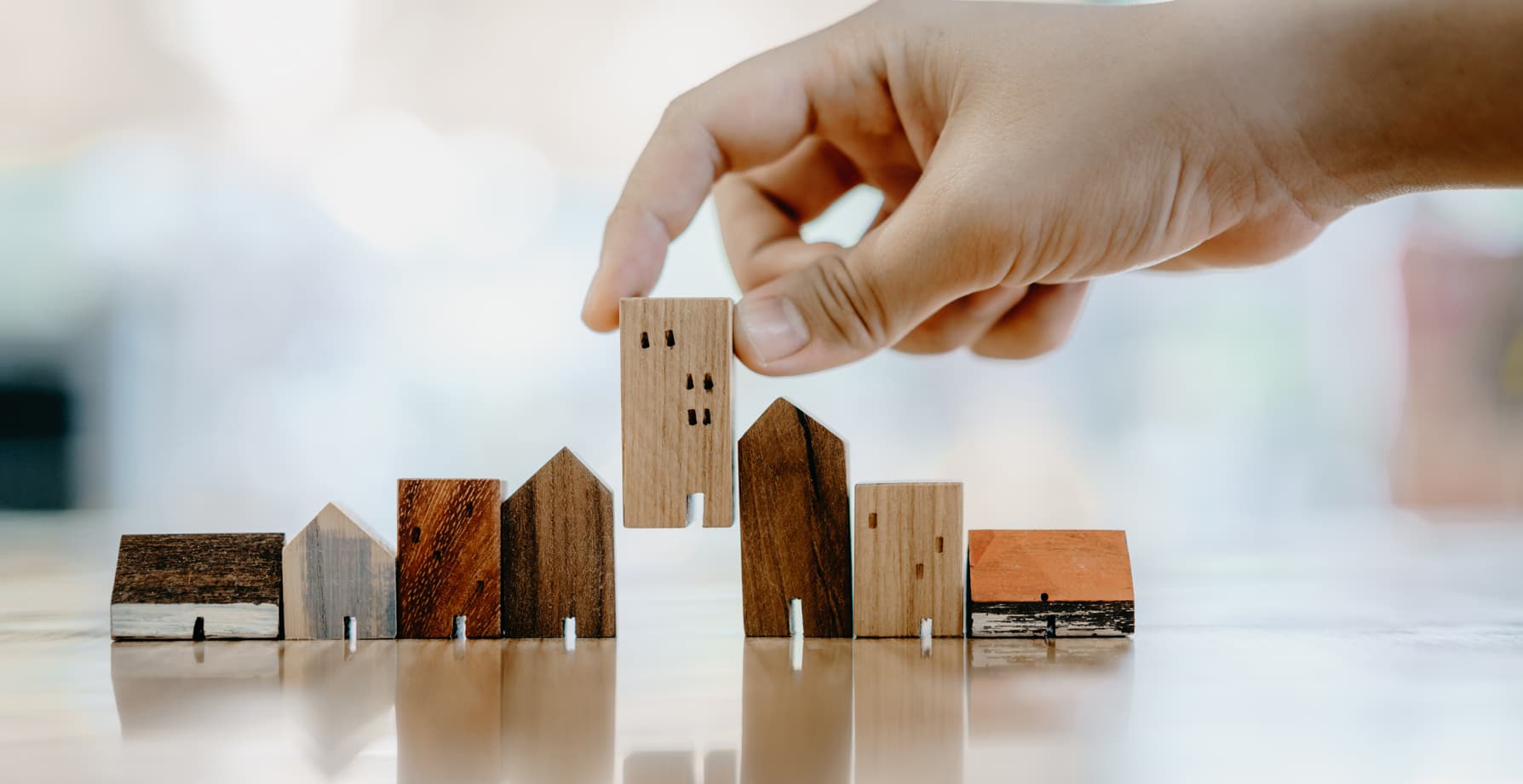 Closeup of small, wooden houses being lined up.